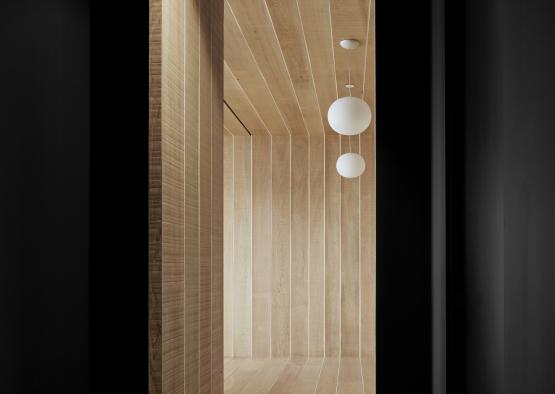 a room with a wood wall and ceiling with light bulbs