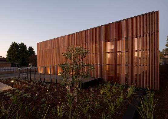 a building with a fence and plants