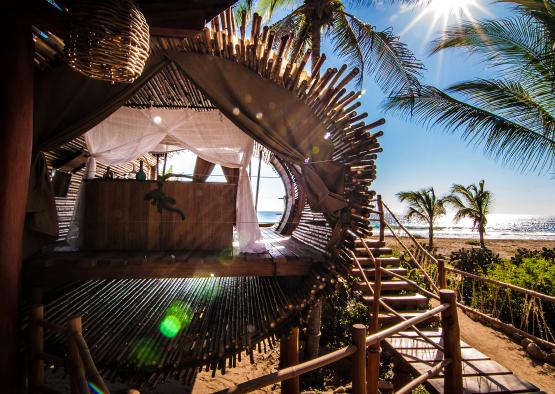 a wooden structure with a beach and palm trees