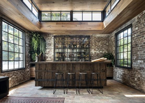 a bar in a room with a window and a wood wall