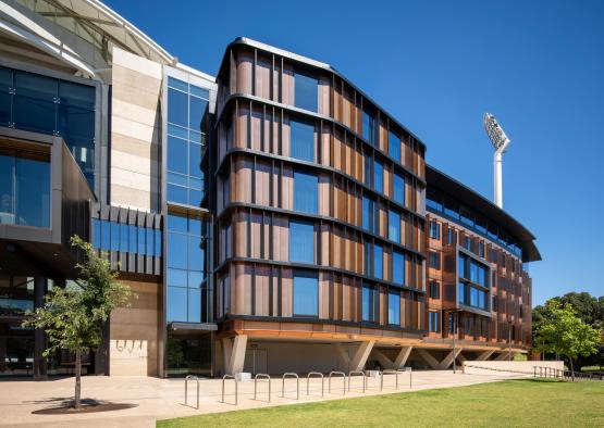 a building with glass walls and a lawn