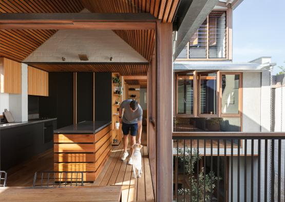 a man and dog walking on a porch