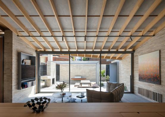 a room with a glass wall and a table and chairs