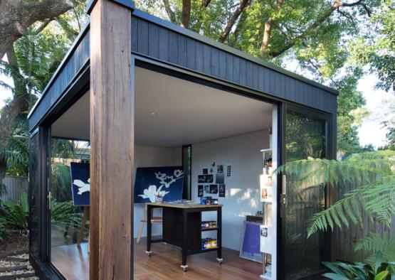 a glass building with a desk and a wood floor