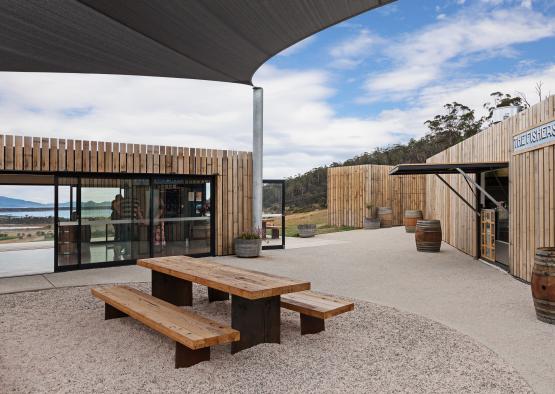 a picnic table and benches outside a building