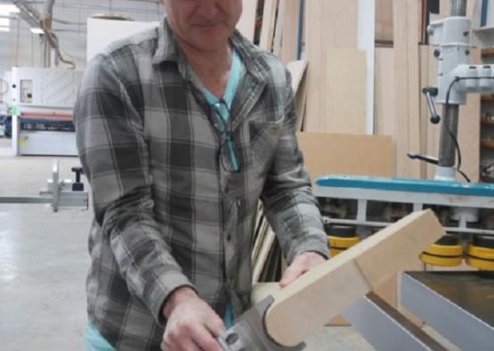 a man working on a piece of wood