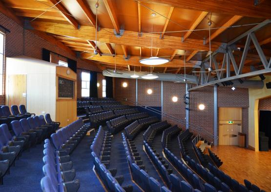 a large auditorium with blue seats