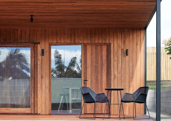 a wooden house with chairs and a table