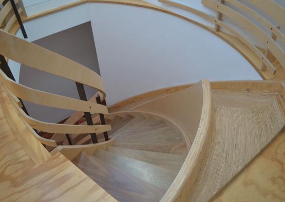 a spiral staircase with wooden railings