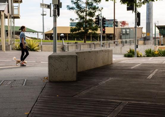 a woman running on a sidewalk