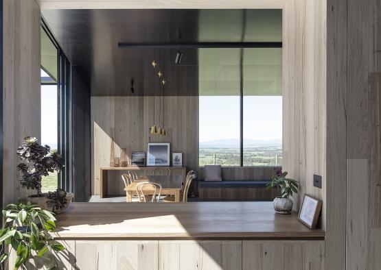 a room with a table and chairs and a window