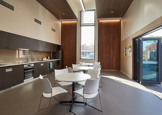 a room with white tables and chairs