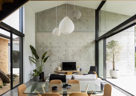 a room with glass walls and a table and chairs