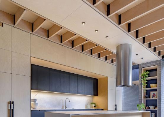 a kitchen with a bar and stools