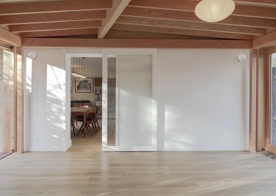 a room with a dining table and a sliding door