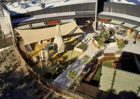 a playground with a fence and a building