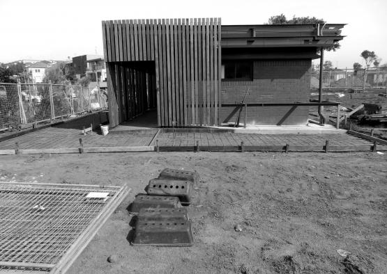 a building under construction with a fence