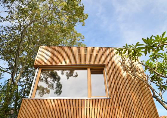 a wood wall with a window and trees