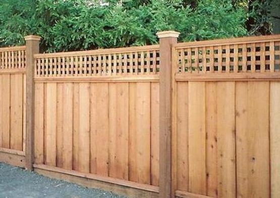 a wooden fence with a lattice top