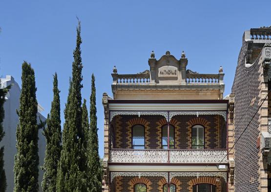 a building with trees and a fence