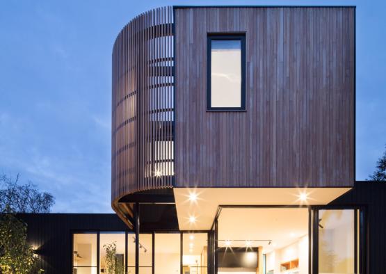 a house with a wood paneled wall and a wooden staircase