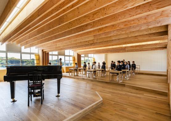 a group of people in a room with a piano