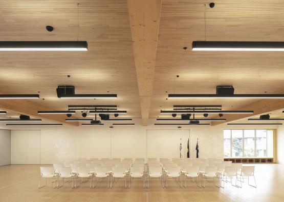 a room with white chairs and a wood floor