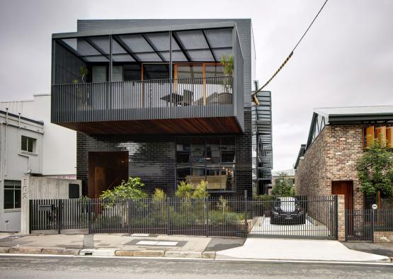 a building with a fence and a car