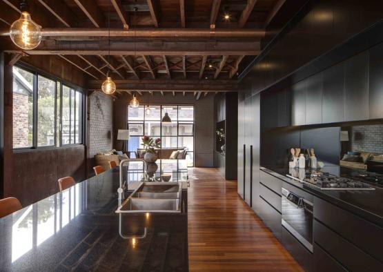 a kitchen with a wood floor and a wood ceiling