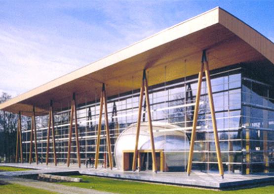 a building with glass walls and a large round dome