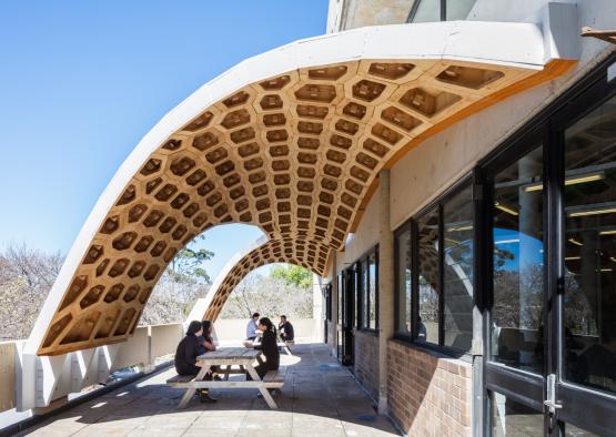 people sitting on a bench under a building