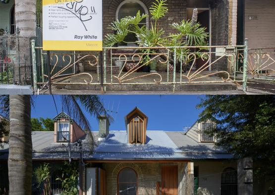 a house with a fence and a sign