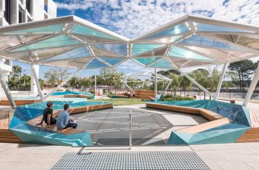 people sitting on benches under a roof