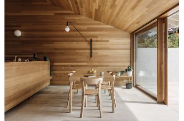 a dining table and chairs in a room with a glass wall