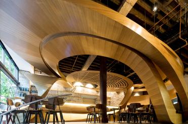 a room with a curved ceiling and chairs