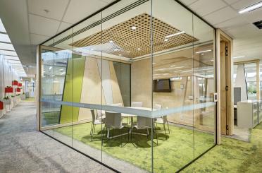 a glass wall with a table and chairs in it