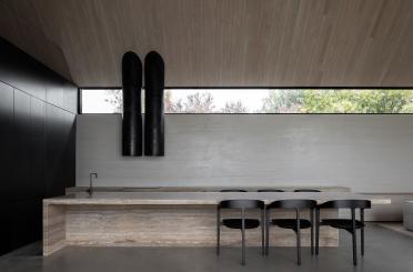 a kitchen with a counter and chairs