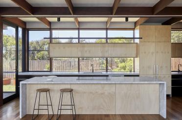 a kitchen with a bar and stools