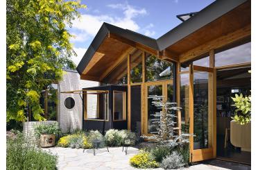 a building with a glass wall and a tree