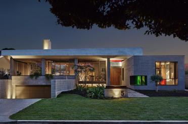 a house with a lawn and a large driveway