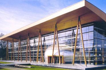 a building with glass walls and a large round dome